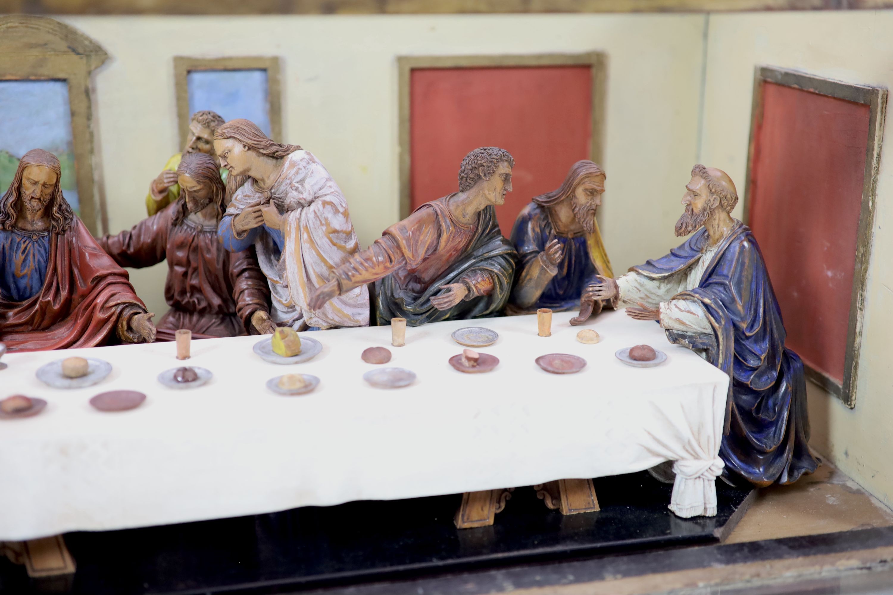 Attributed to Hans Mayr (active 1870) - a carved and painted limewood tableau of The Last Supper, after Leonardo da Vinci, dated 1872 32cm high, 94 x 33cm.
